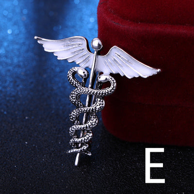 Silver caduceus symbol with wings on a dark background