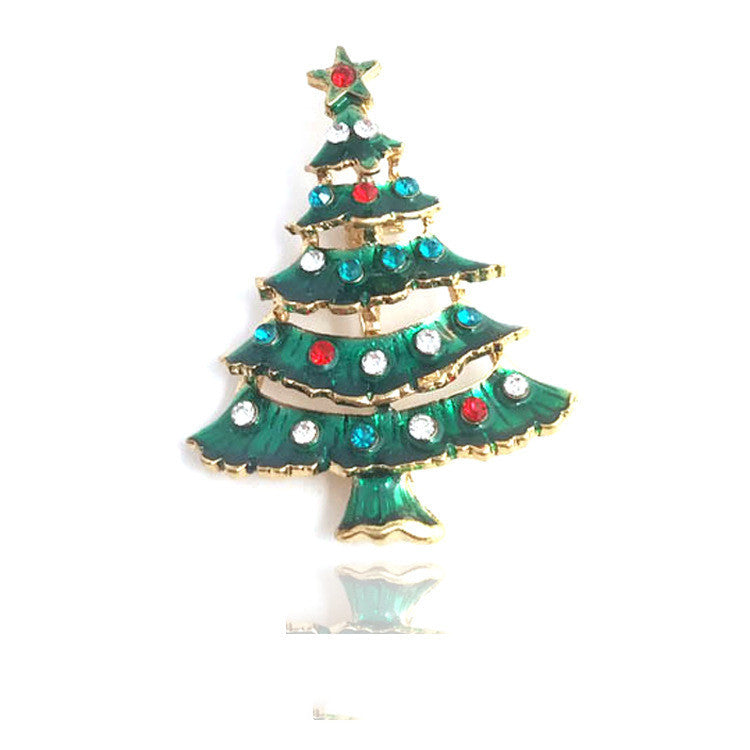 Christmas tree-shaped brooch with colorful gemstones on a white background