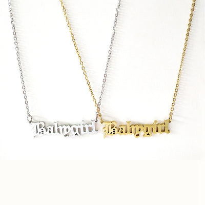 Two necklaces with 'Babygirl' pendant, one in gold and one in silver, on a white background.