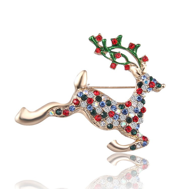 Decorative reindeer brooch with multicolored gemstones on a white background