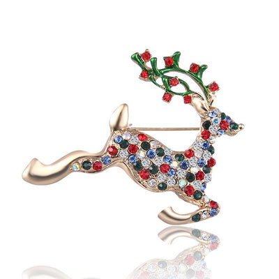 Decorative reindeer brooch with multicolored gemstones on a white background