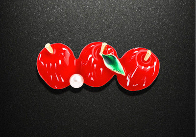 Red cherry-shaped object with measurements on a black background