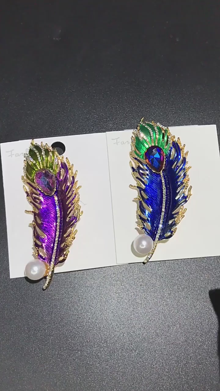 video of Colorful feather-shaped brooches with gemstones and a pearl 